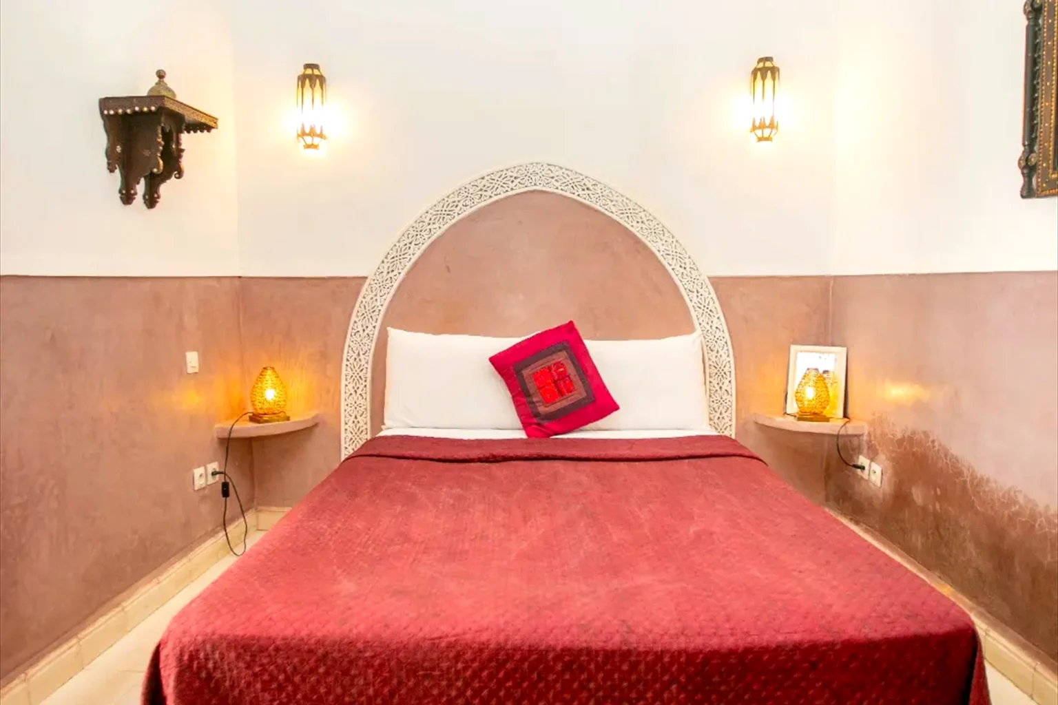 Dar Damana guest suite with terracotta textiles and carved cedar